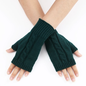 Detail of dark green cable knit fingerless gloves with stylish braided pattern