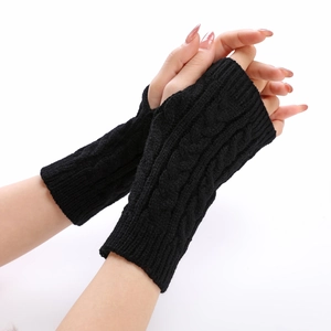 Detail of black cable-knit arm warmers with thumb holes on model's hands