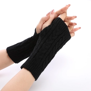 Close-up of black cable-knit arm warmers featuring thick texture and fingerless design