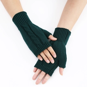 Detail view of dark green cable knit fingerless gloves with a classic twist pattern