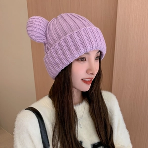 Detail of light purple knitted beanie with cute bear ears and thick ribbed texture