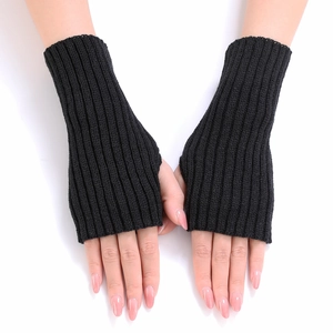 Detail view of black ribbed knit fingerless gloves showing elastic texture and thumb hole