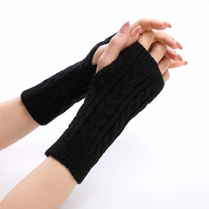 Detail of black cable knit arm warmer with thumb hole and textured stitching