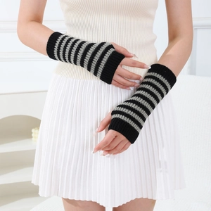 Detail of grey and black striped knitted arm warmers with a fingerless design for women