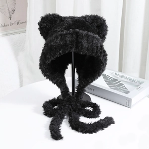 Detail of plush black cat ear hat featuring soft faux fur texture and long chin straps