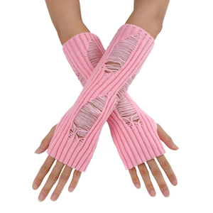 Macro detail of pink knit arm warmer featuring distressed hole design and Y2K punk style