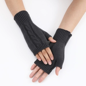 Detail view of dark grey cable knit fingerless gloves with ribbed elastic cuffs