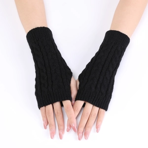Close-up of black cable-knit arm warmer with thumb hole and intricate braided pattern