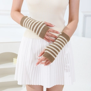Detail of brown and white striped knit fingerless gloves with ribbed cuffs texture