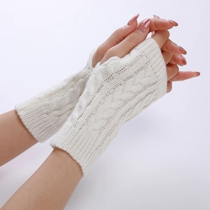 Detail of white cable knit thumbhole sleeve covers showing thick wool texture