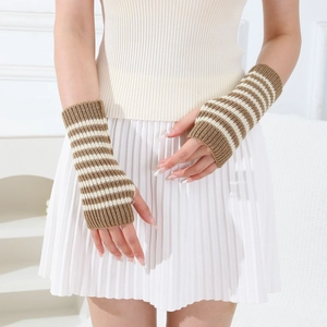 Detail of striped knitted fingerless gloves in brown and white with elastic texture