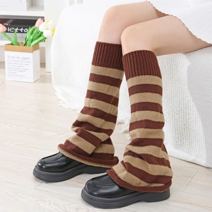 Close-up of brown striped knitted leg warmers with ribbed cuffs in a vintage style