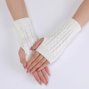 Close-up of white cable knit fingerless gloves showing thumb hole and warm texture