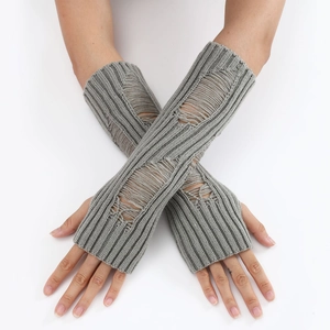 Macro detail of grey ribbed knit fingerless gloves with distressed punk hole design