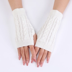 Detail of white cable knit arm warmers showing soft wool texture and fingerless design