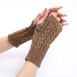 Close-up of brown cable-knit texture on winter fingerless arm warmers for women