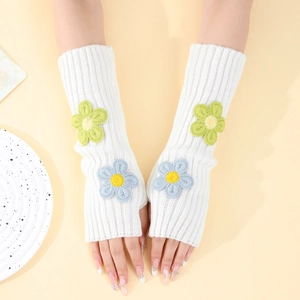 Detailed close-up of white knit arm warmers featuring colorful 3D embroidered flowers