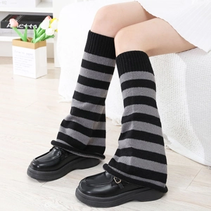 Detail of grey striped knit leg warmers with ribbed cuffs for winter outfits