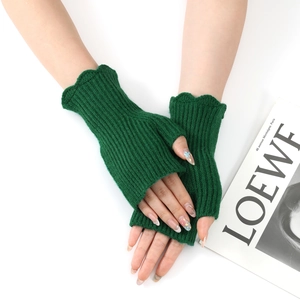 Close-up of dark green ribbed knit fingerless gloves with delicate ruffled edges