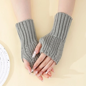 Détail de mitaines en tricot gris avec motif torsadé et poignets côtelés pour femme