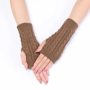 Detailed cable knit pattern on brown fingerless gloves with thumb hole for winter