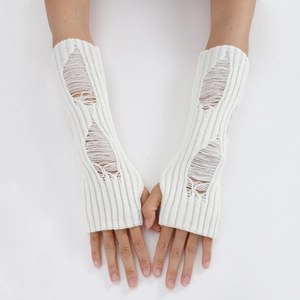 Detail of white distressed knit arm warmers with punk-style ripped hole patterns