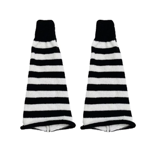 Close-up of black and white striped knit leg warmers featuring high elastic ribbed cuffs