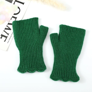 Detailed view of dark green ribbed knit fingerless gloves with scalloped wave edge
