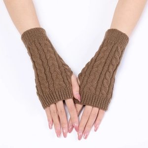 Detailed cable knit pattern on brown fingerless gloves with a stylish ribbed cuff