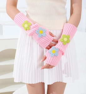 Detailed knit texture of pink arm sleeves with cute 3D crochet flower embellishments