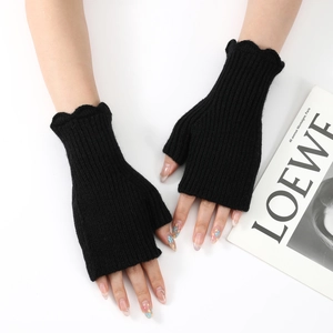 Detail of black ribbed knit fingerless gloves with elegant wavy edge trim for women