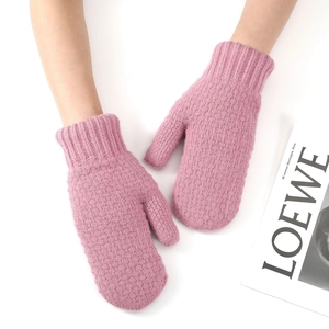 Close-up of pink knit mittens featuring elastic ribbed cuffs and thick warm yarn texture