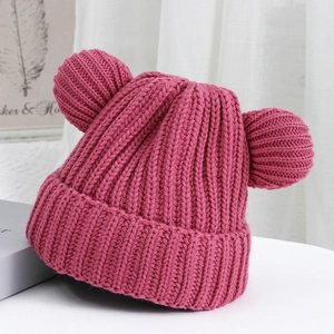 Close-up of pink knitted hat featuring cute bear ears and detailed ribbed texture