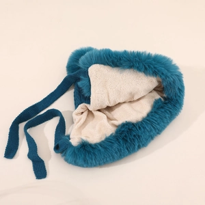 Detail of dark blue trapper hat with faux fur trim and warm sherpa fleece lining