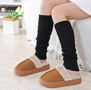 Detailed knit texture of cable pattern leg warmers paired with cozy fur-trimmed slippers