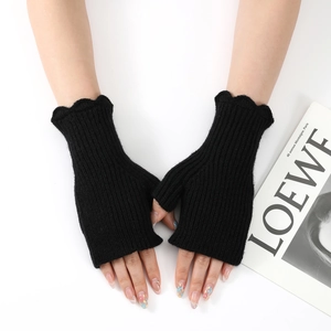 Close-up of black ribbed knit fingerless gloves featuring stylish ruffled wave cuffs