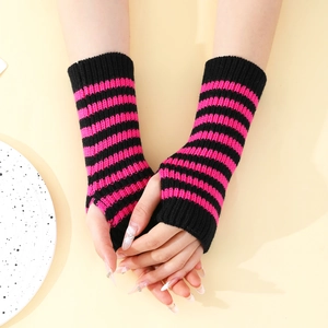 Detailed knit texture of pink and black striped fingerless gloves with thumb hole