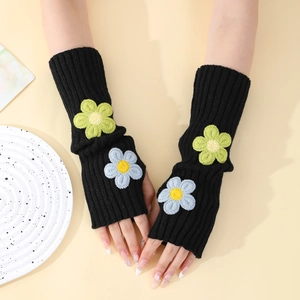 Detailed knit texture of black Y2K fingerless gloves with daisy flower embroidery