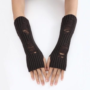 Detailed close-up of dark brown knit arm warmers with trendy distressed ripped texture