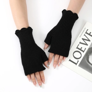 Detail of black ribbed knit fingerless gloves with elegant wavy ruffled edges for women