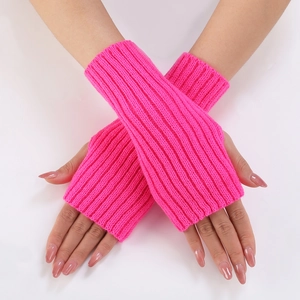 Detailed texture of fluorescent pink knitted fingerless gloves with ribbed weave pattern