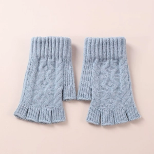 Close-up of light blue cable knit fingerless gloves with elastic ribbed cuffs