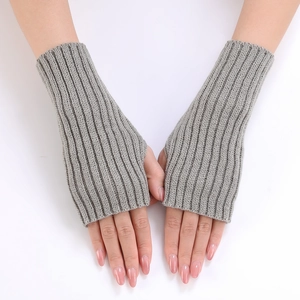 Detailed view of grey knitted fingerless gloves with a soft vertical ribbed pattern