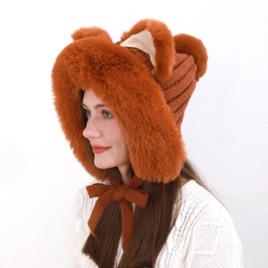 Detail of orange fox ear beanie with soft faux fur trim and knitted bow tie closure