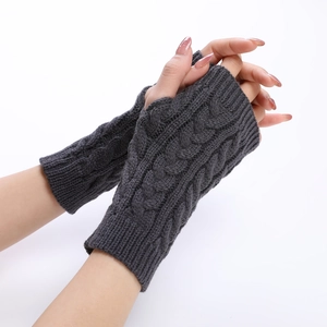 Detailed cable knit pattern on dark grey fingerless gloves with thumb hole design