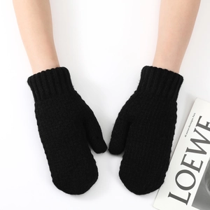 Close-up of thick black knitted mittens featuring long ribbed elastic cuffs for winter warmth