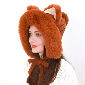 Detail of plush fox ear hat in caramel orange with soft faux fur and knit chin ties