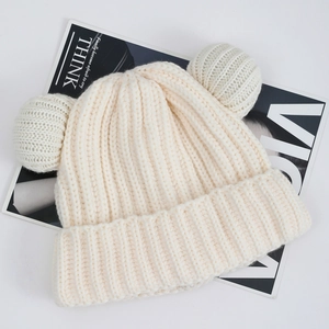Detail of cream rib-knit beanie with cute bear ears and thick thermal texture