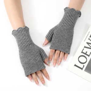 Close-up of grey ribbed knit fingerless gloves with elegant ruffled edges and thumb hole