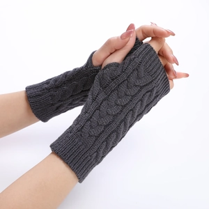 Macro detail of dark grey cable knit pattern on fingerless arm warmers for women